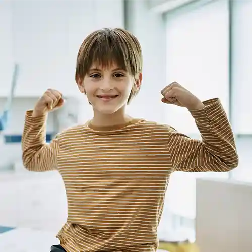A Boy Smiling while making a victory appearance