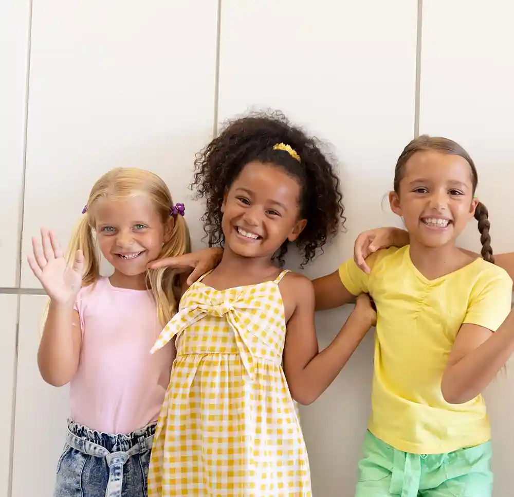 Three girls smiling at camera