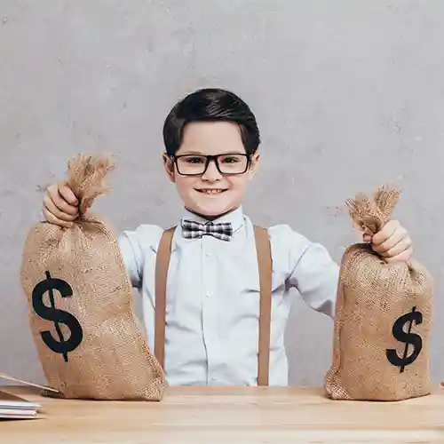 A Boy smiling at camera after collecting mini cash bags